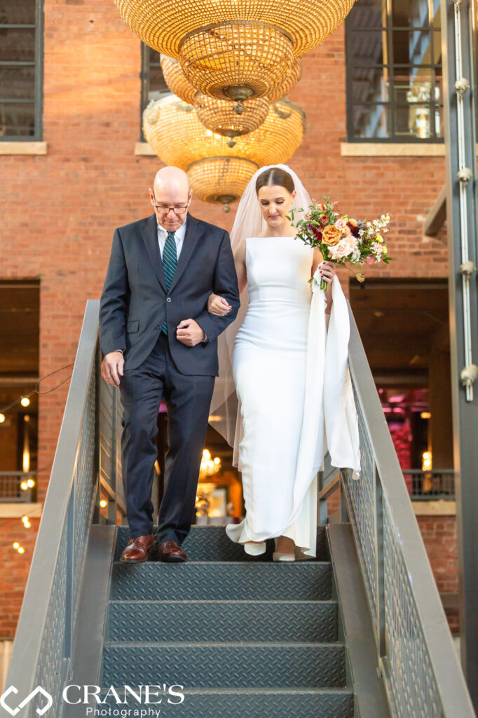 A father and his daughter, the bride, are en route to a wedding ceremony taking place at the North Atrium of Artifact Events.