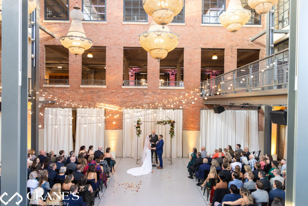 The North Atrium at Artifact Events provides a distinctive space for wedding ceremonies with multi-level ceilings and elegant chandeliers.