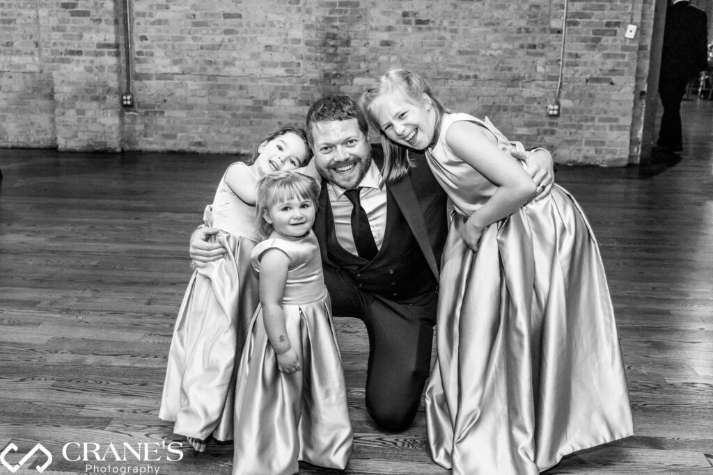 The groom and his flower girls are joyfully celebrating his wedding day at the North Atrium of Artifact Events.
