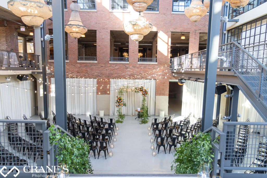North Atrium of Artifact Events elegantly decorated with flowers and string lights for a Jewish wedding ceremony.
