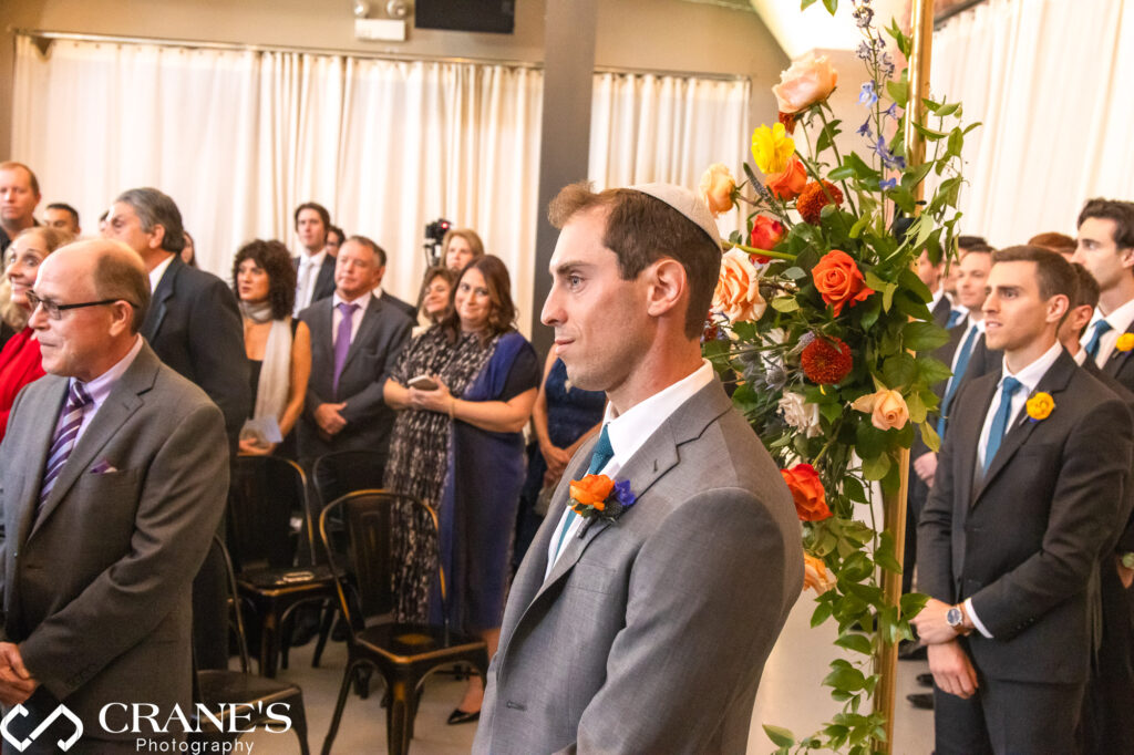 Groom's first look during a Jewish wedding ceremony at Artifact Events, a special and emotional moment.