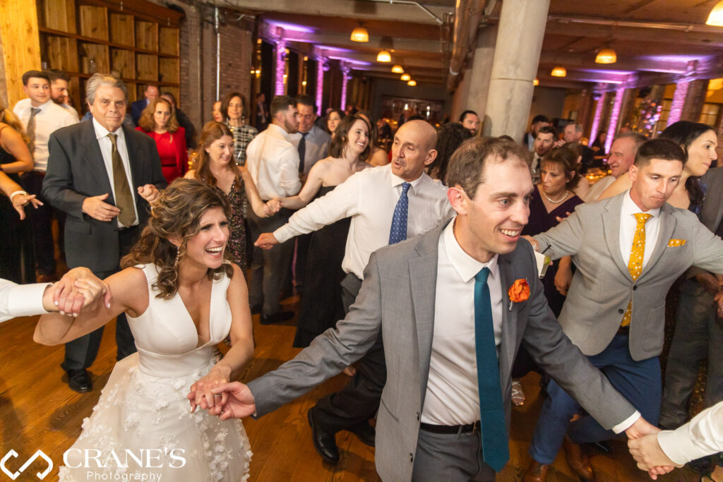 The Hora, a traditional Jewish wedding dance where everybody dances in a circle, being performed at Artifact Events, adding lively and celebratory vibes to the wedding.