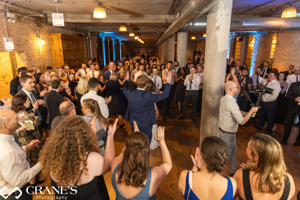 The dance floor during a Jewish wedding reception at Artifact Events, filled with guests joyfully celebrating the newlyweds' special day.