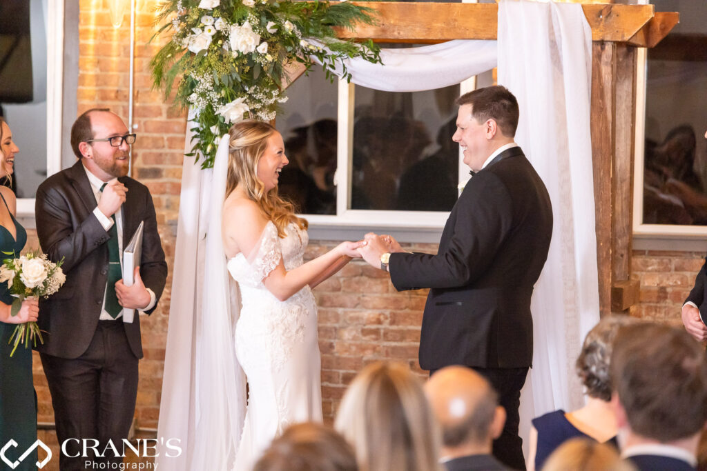 The bride and groom are over the moon as they are joyfully announced as husband and wife during their wedding ceremony at City View Loft, radiating happiness and excitement.