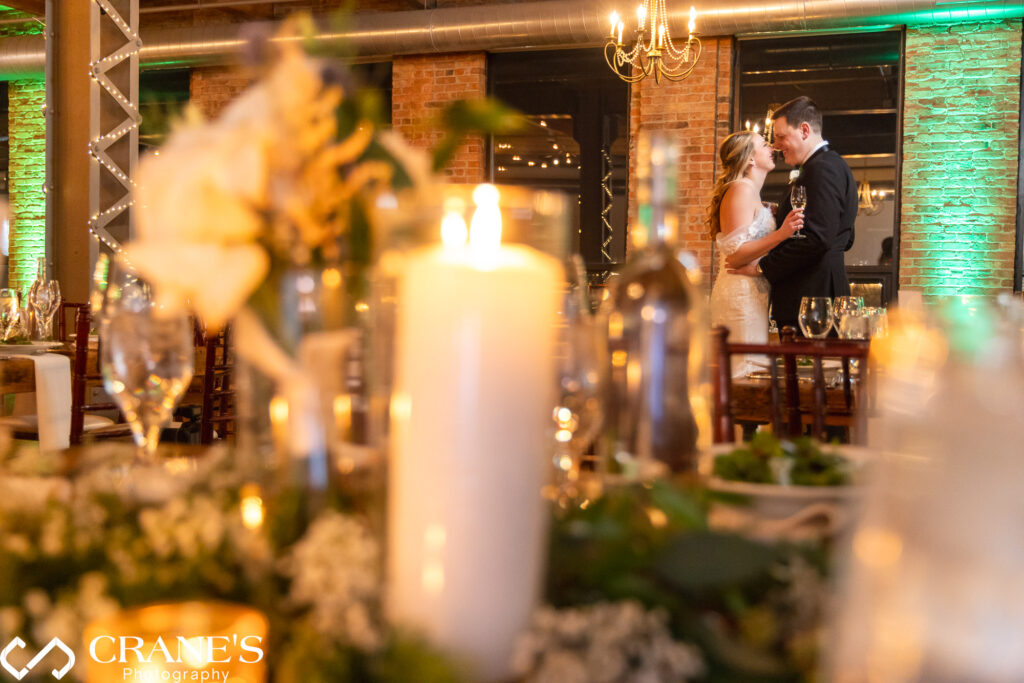 The bride and groom steal a sneak peek at their wedding reception hall at City View Loft, eagerly anticipating the celebration that awaits.
