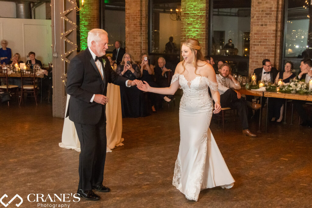 In a tender moment at City View Loft, the bride and her father share a heartfelt dance, capturing the love and emotion of this special father-daughter moment on her wedding day.