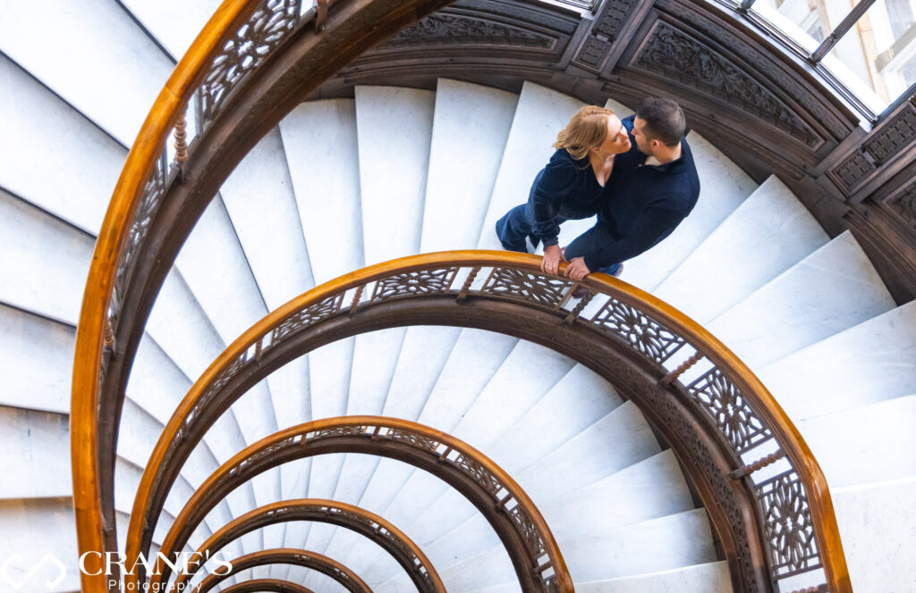 An elegant masterpiece unfolds on the spiral staircase of the Rookery Building in Chicago, where architectural grace meets timeless sophistication, creating a stunning visual composition.