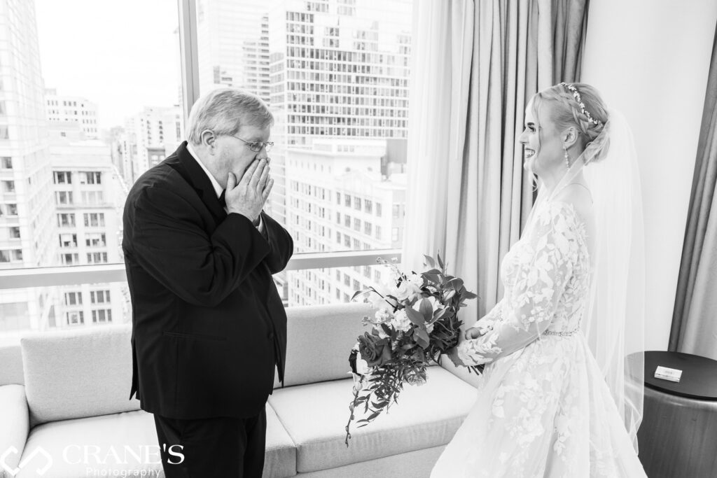 The emotional first look: The father of the bride beholds his daughter for the first time in her wedding gown, creating a heartfelt moment in the elegant surroundings of the theWit hotel just before the wedding ceremony.