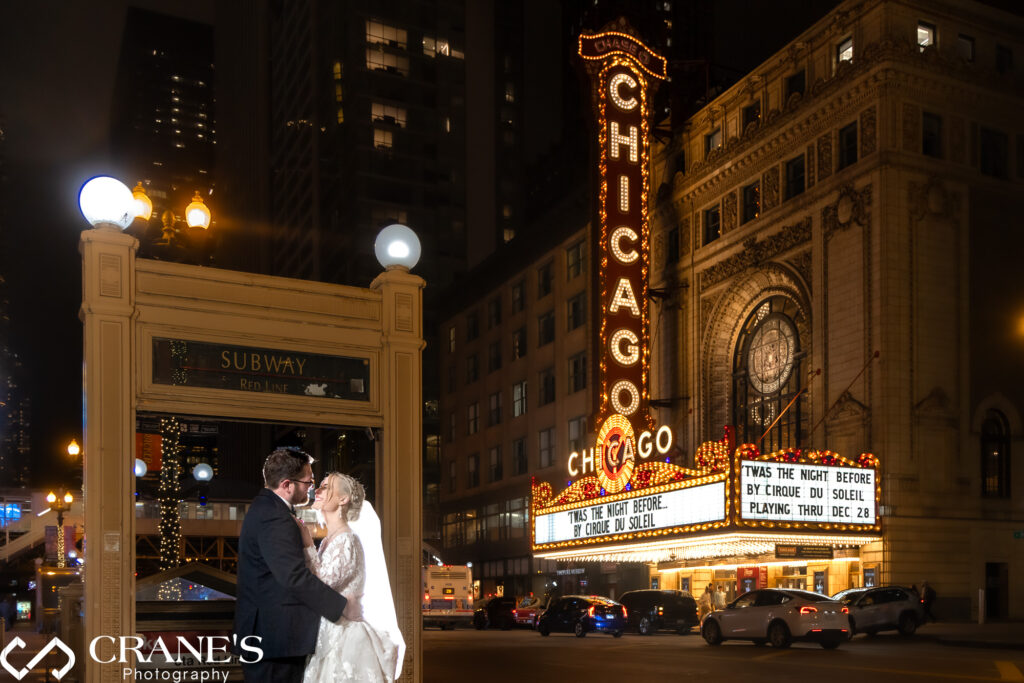Wedding photos of the Chicago Theatre at night.