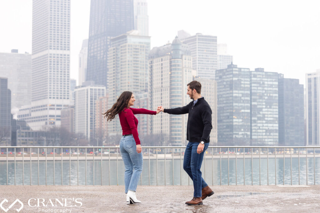 A captivating winter engagement session in downtown Chicago with a casually stylish couple wearing jeans. The image captures the essence of their love amidst the enchanting urban winter charm.