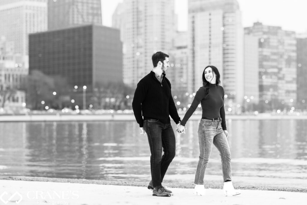 The couple embraces the winter magic on Oak Street Beach in downtown Chicago, covered in a blanket of snow, as they capture the essence of their engagement in a picturesque setting.