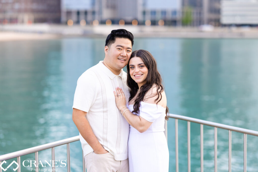 An elegant couple poses for an engagement photo at Olive Park. The couple's attire exudes sophistication, and their loving gaze towards each other captures the essence of their commitment and anticipation for the journey ahead.