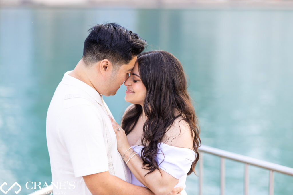 A romantic kiss shared during an engagement session at Olive Park. The couple's embrace is tender and heartfelt and it's set against the backdrop of Lake Michigan.