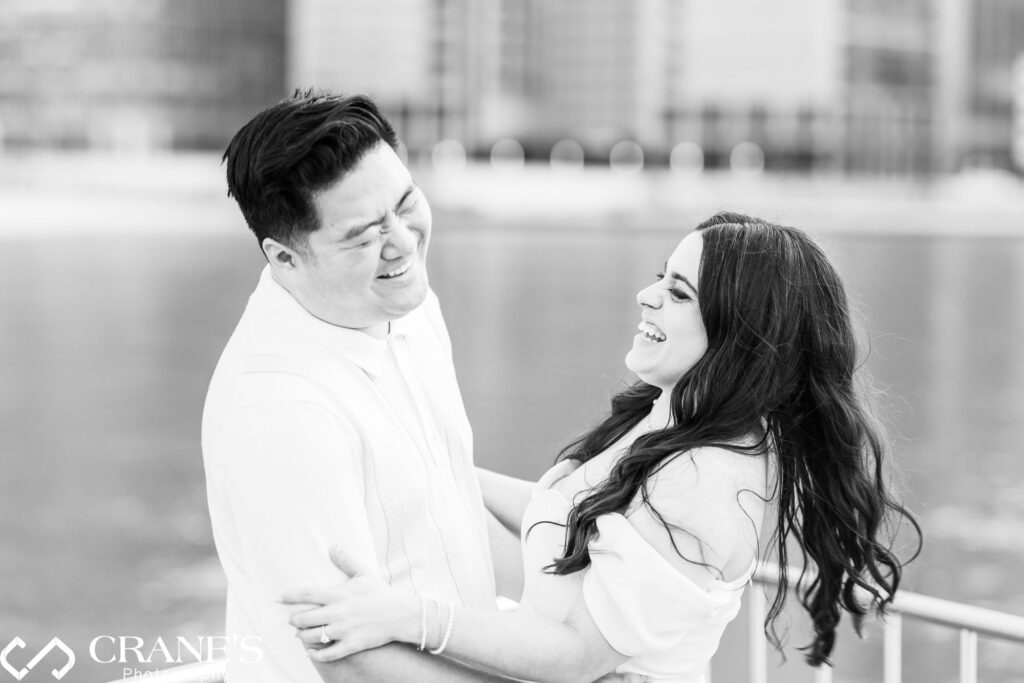 Candid Olive Park engagement photo of a couple laughing together.