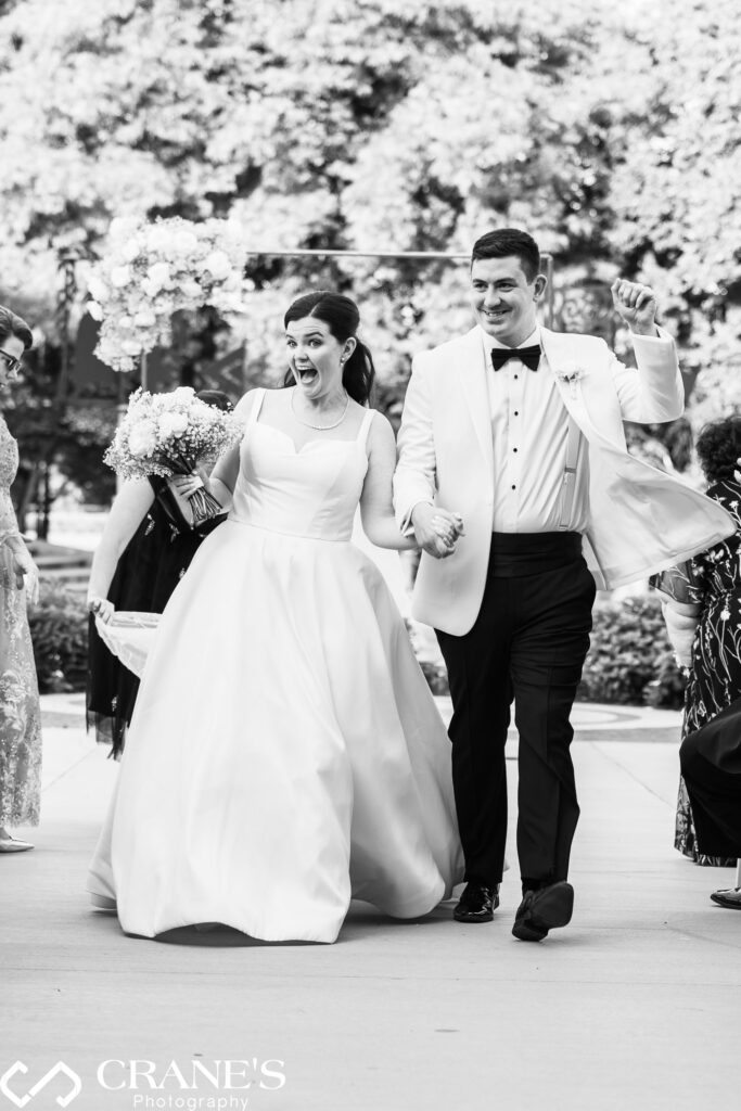 Just married! Joyful bride and groom embrace at Uihlein Plaza, Chicago History Museum.