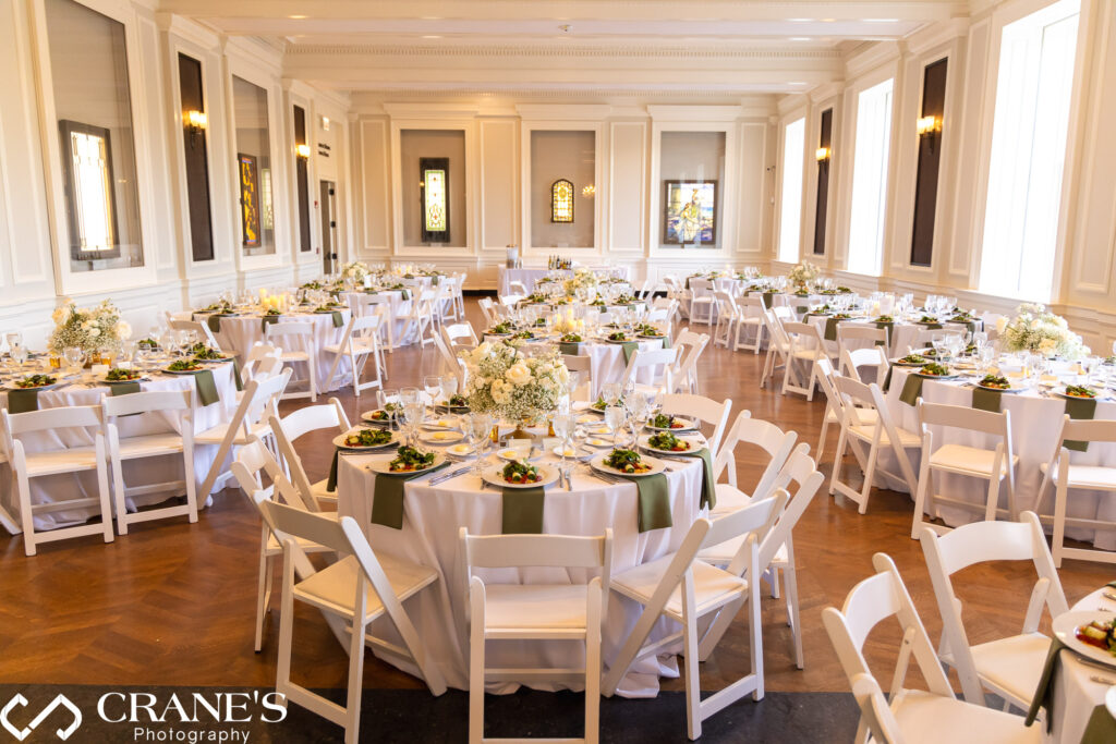 The Chicago Room at the Chicago History Museum, is elegantly decorated for a wedding reception. The grand architecture provides a timeless backdrop, complemented by tasteful decorations that enhance the sophisticated ambiance of the venue.