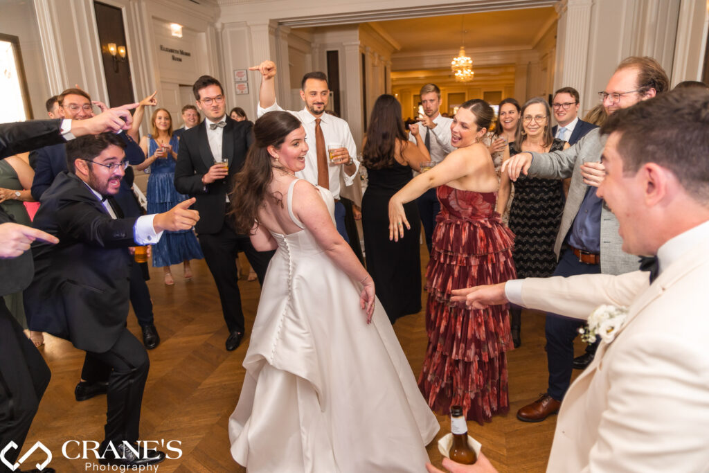 Pure joy! Wedding guests light up the dance floor at the Chicago History Museum reception. Energetic party under the museum's grand architecture.