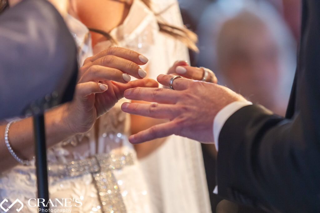 A close-up image of the rings as the bride and groom exchange them during their wedding ceremony at RPM Events.