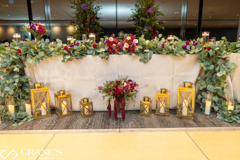 Wedding reception table set with fall-inspired decor, including autumn-colored centerpieces and elegant table settings.