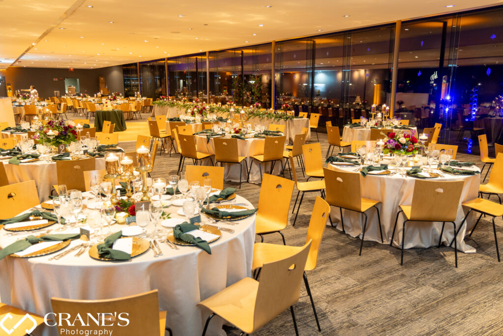 Candlelit wedding reception in the Ginkgo Room at the Morton Arboretum, with warm, glowing candles creating an intimate and romantic atmosphere. The elegant setup features fall-themed decor and soft lighting that enhances the enchanting ambiance