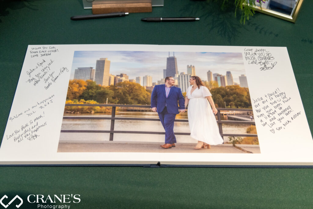 Engagement album displayed on a reception table at Julia and David's Morton Arboretum wedding, allowing guests to flip through images of their journey as a couple.