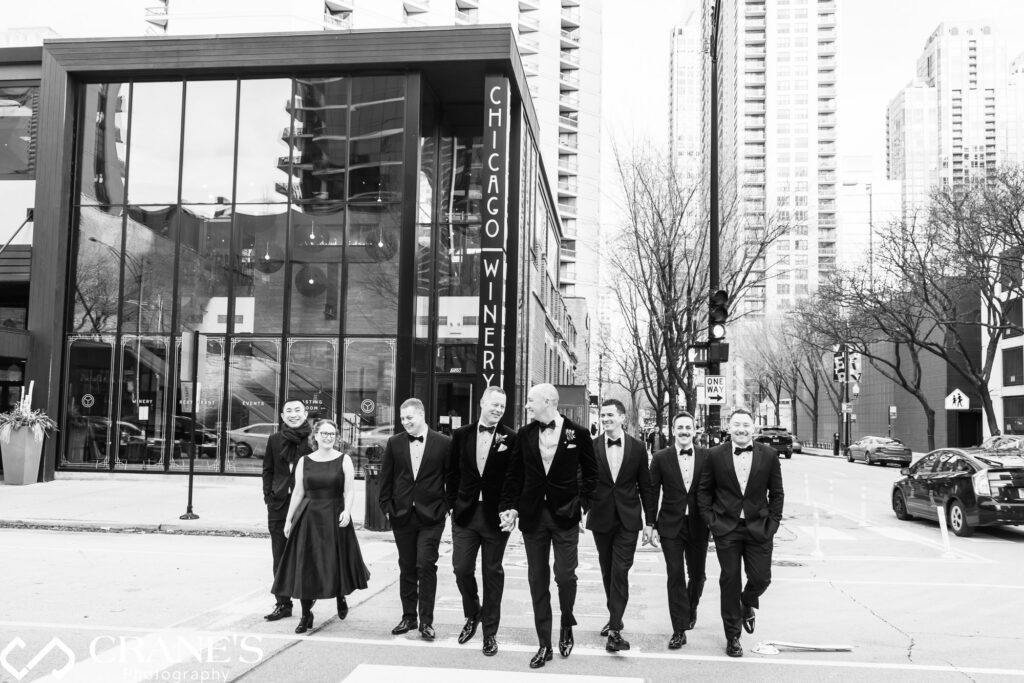 A gay couple and their wedding attendants cross the street outside the Chicago Winery.