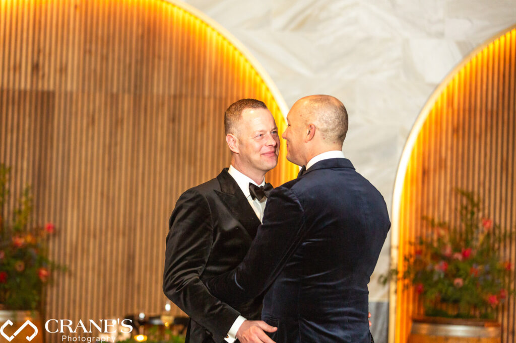 Night photo of a gay couple sharing their first dance at their wedding reception at Chicago Winery.