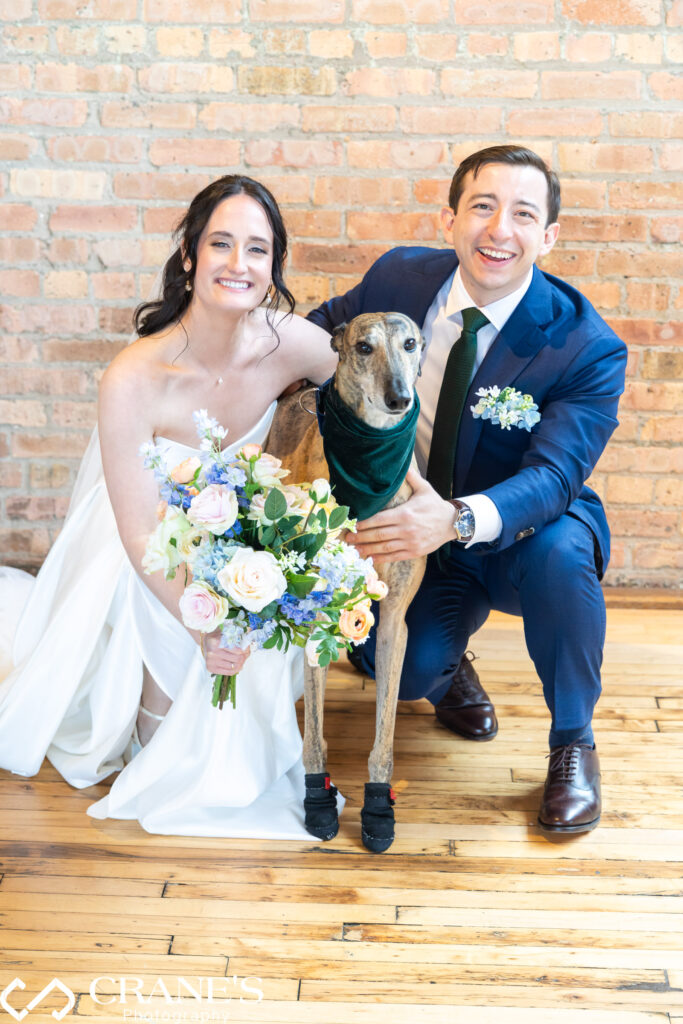 Bride and groom pose with their dog before their wedding ceremony at the Skyline Loft at Bridgeport Art Center.